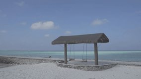 Maldives. Coast of the tropical ocean with a swing for tourists. Flat ungraded RAW 4k footage