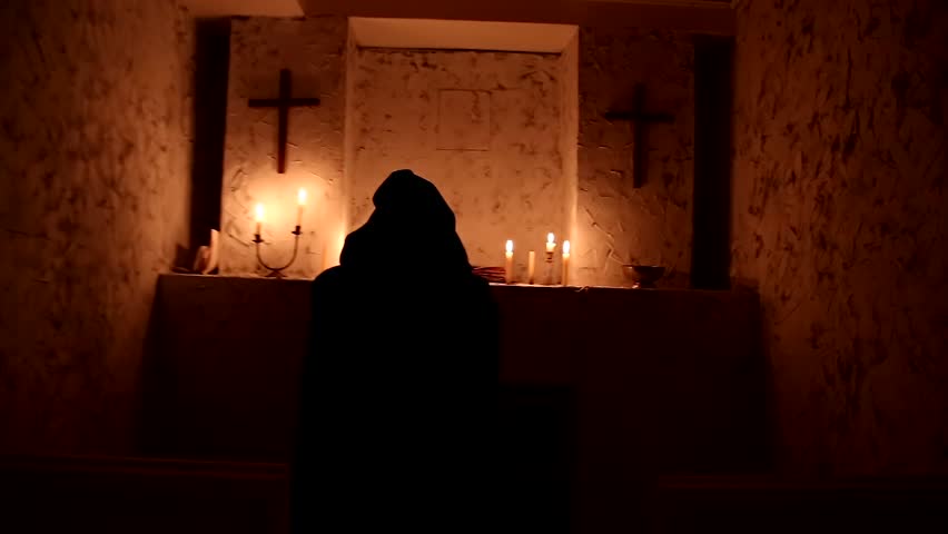 The monk walks the dark room to the altar Royalty-Free Stock Footage #1010720783