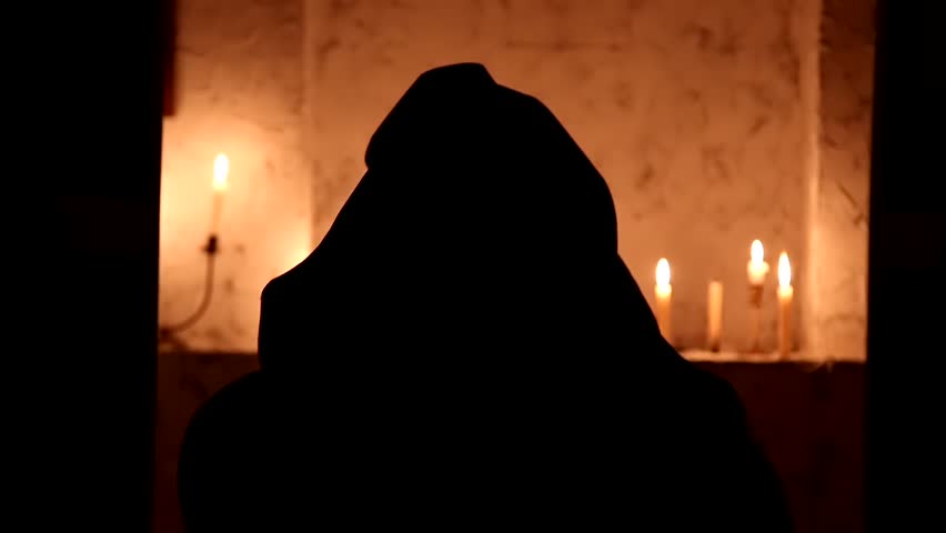 The monk walks the dark room to the altar Royalty-Free Stock Footage #1010720786