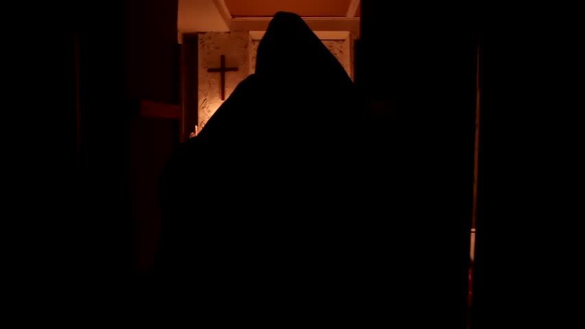 The monk walks the dark room to the altar Royalty-Free Stock Footage #1010720789