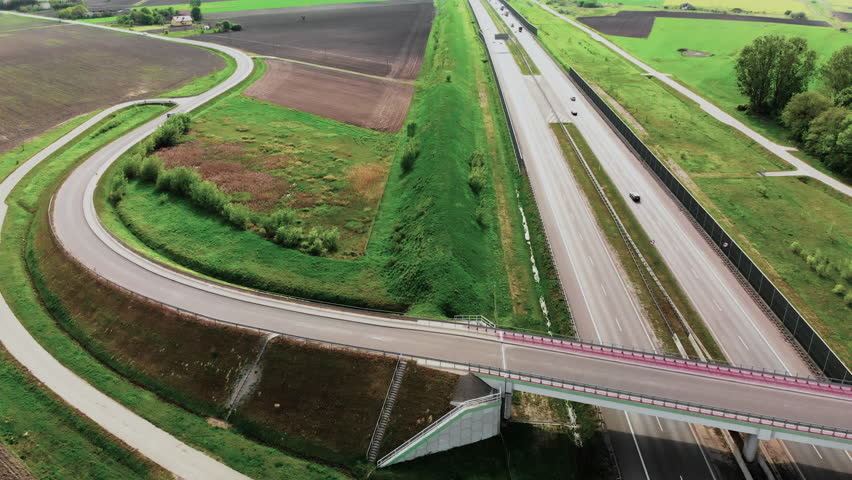 Large road. Day traffic. Aerial drone flight above. Summer spring day.