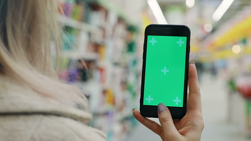 woman hands using mobile smart phone in department store supermarket blur bakcground close up view female shopping online application for checking price app modern comfortable lifestyle buying