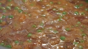 Tasty meat stew with green peas 4K footage