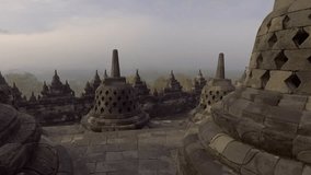 SLOW MOTION video of travel man contemplating sunrise at Borobudur temple, Indonesia .
People travel adventure concept