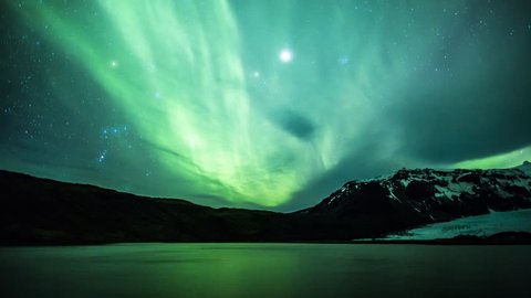 4K Aurora Borealis over a glacier lagoon lake