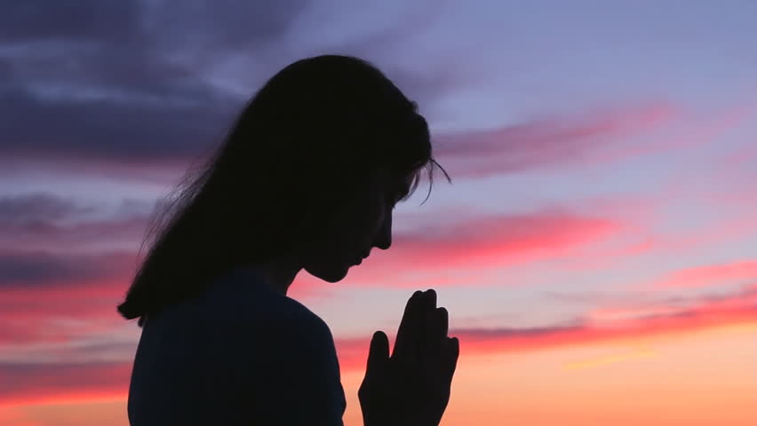 Praying girl silhouette colorful sunset. Woman with gratitude pray looking up and raising open hands to sky Royalty-Free Stock Footage #1010751170