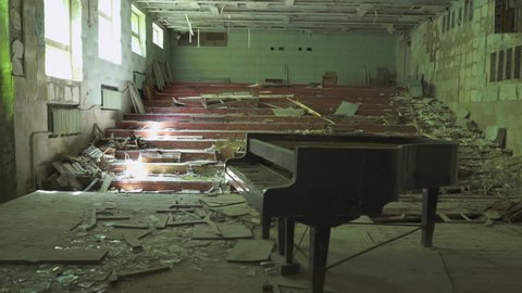 Abandoned concert hall with a piano in Pripyat. Chernobyl nuclear disaster. Slider shot - Juni 2017: 30km Chernobyl, exclusion zone