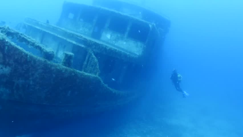 Scuba diver exploring ship wreck underwater shipwerck | Shutterstock HD Video #1010763305