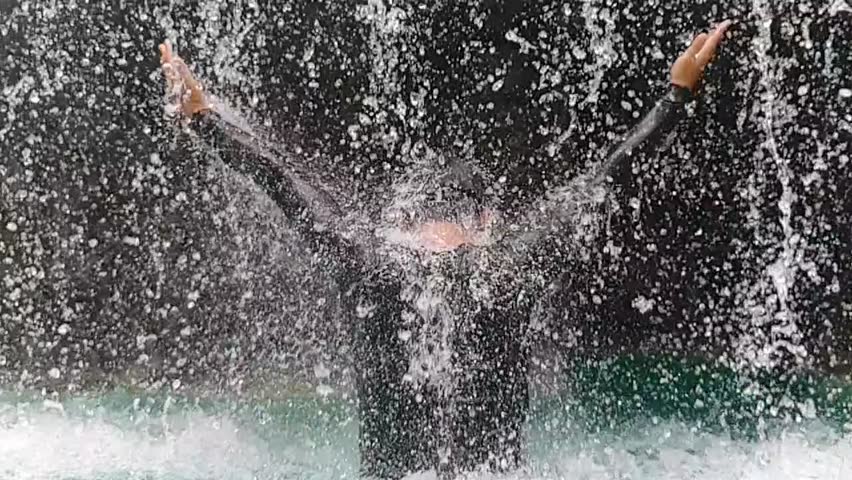 Man standing in waterfall  
