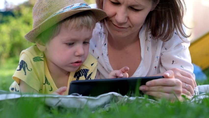 Little boy Playing with Tablet with his mother
