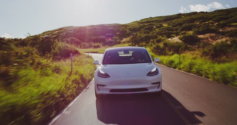 CALIFORNIA, USA - CIRCA APRIL 2018: The much anticipated Tesla Model 3 electric vehicle driving on country road.