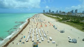 Drone aerial footage Miami Beach establishing shot crowds of tourists 4k 60p