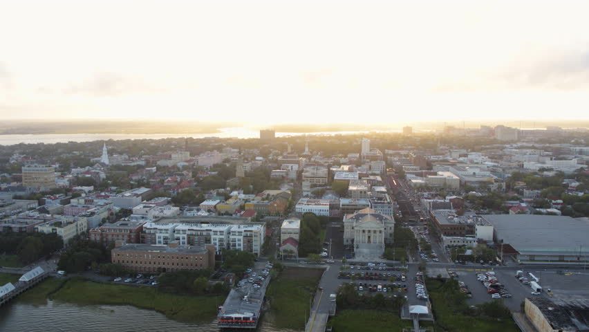 South Carolina Charleston Aerial v128 Flying low to high backwards around French Quarter and port with city view at sunset 10/17