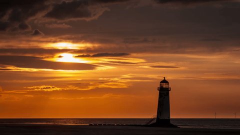 4k time lapse Point of Ayr lighthouse, Talacre, North Wales with colourful clouds at sunset