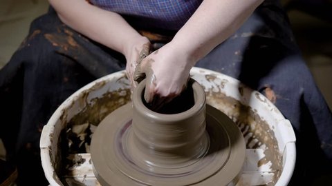 Female Potter Craftsman Helps Student