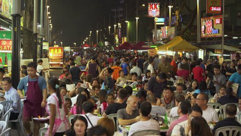 Crowd of people enjoy food on Jalan Alor food street at night - October 2017: Kuala Lumpur, Malaysia