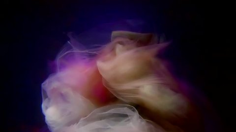 mystic silhouette of ghost of bride in sea deepness in dark blue and purple illuminations, she is playing with her dress Arkivvideo