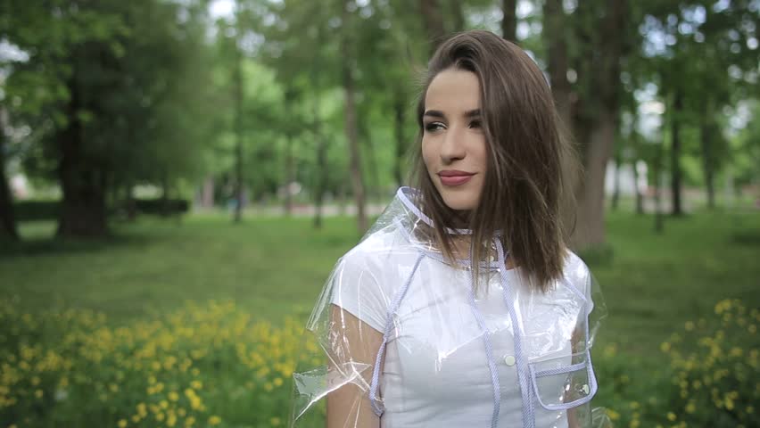 Transparent raincoat, girl walk in the park, cloudy weather, raincoat