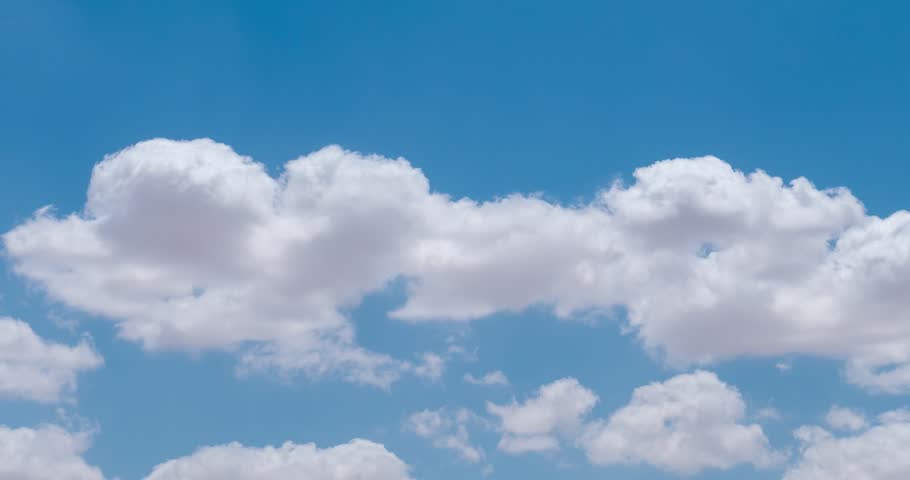 White fluffy clouds moving in the blue sky | Shutterstock HD Video #1010818199