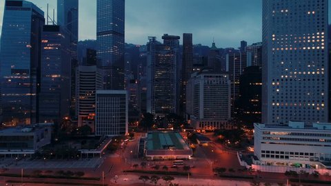 AERIAL. Night panoramic shot of Hong Kong city centre. Camera moving from down to top.