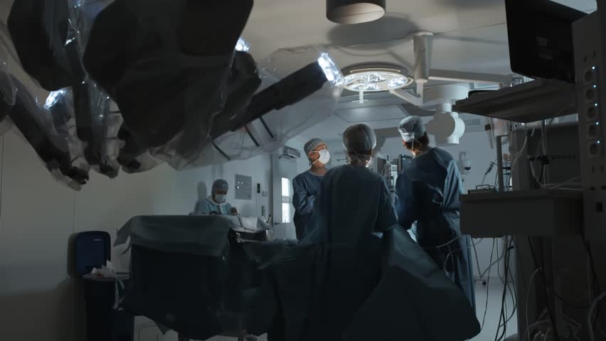 Operating room, team of surgeons prepares patient to cancer removal surgery via Minimally Invasive Robotic Surgery. Hi-tech medical robot, modern medicine, futuristic medical equipment, operation Royalty-Free Stock Footage #1010832131