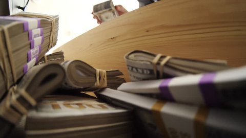 Funny absurd video concept of a man hiding his money inside a wooden drawer.