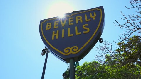 Beverly Hills sign with sunbeam, Los Angeles. Slider shot - August 2017: Los Angeles California, US