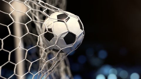 Soccer ball flies into the net on a stadium with yellow and blue lights. In slow motion. Close-up (4k, 3840x2160, ultra high definition)