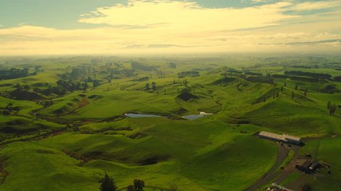 Aerial view of north island of New Zealand, picturesque lush green hills of Matamata region (Shire and Hobbiton from LOTR), fantasy landscape at sunset time, 4k UHD