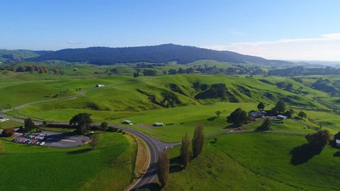 Aerial view of north island of New Zealand, picturesque lush green hills of Matamata region (Shire and Hobbiton - The Lord of the Rings and Hobbit location), sunset time, 4k UHD