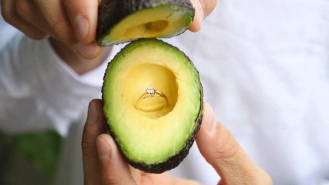 Man Holding Avocado With Engagement Ring to Propose Marriage