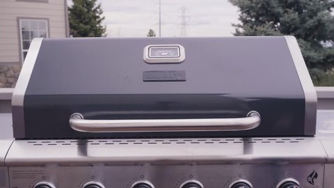 Close up of cast iron cooking grates in six burner outdoor gas grill.