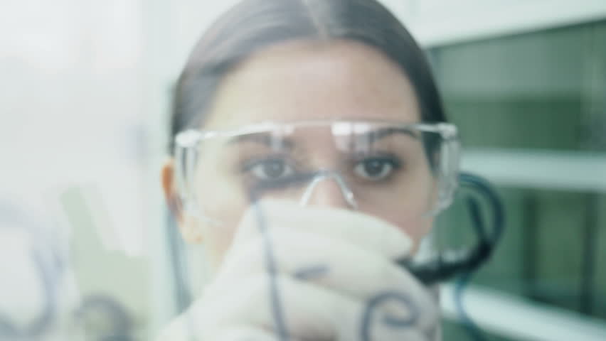 Adult girl after clinical expertise write on the glass discovery way and structural solution of medicaments. Female teacher explaining to pharmacist students pharmaceutical development in university - Powered by Shutterstock - Get 15% off with code: PIKWIZARD15