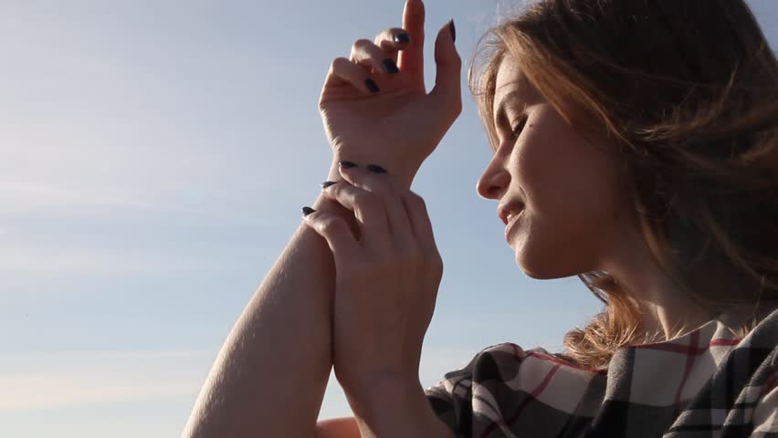 Portrait of beautiful woman on the beach by the ocean wind blows