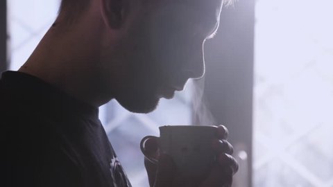 Man Inhales Aroma Of His Fresh Made Cup Of Coffee 