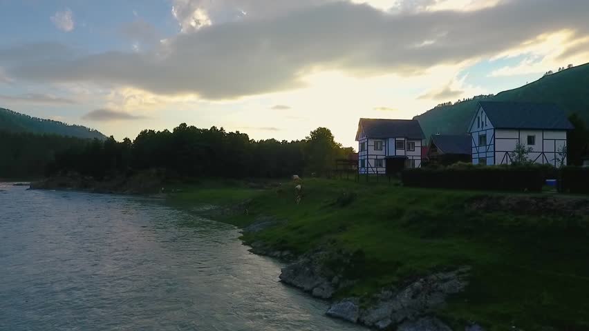 Aerial view of the Katun River and hills during sunset after rain. The Republic of Altai, Russia