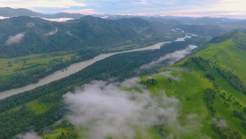 Aerial view of the Katun River and hills during the fog after the rain. The Republic of Altai, Russia