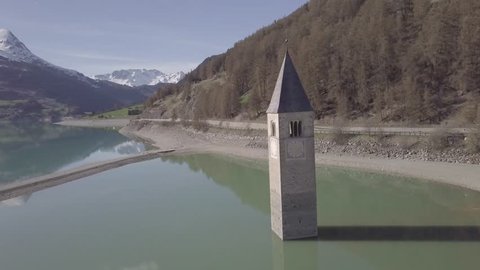 Aerial view of Bell tower in the Resia Lake, Italy, 4k, dlog
