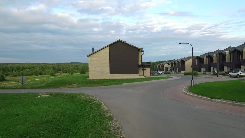 Country houses in the woods. The road between the houses in the forest.
