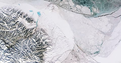 Very high-altitude overflight aerial of uppermost Canada, ice in the Beaufort Sea. Clip loops and is reversible. Elements of this image furnished by NASA
