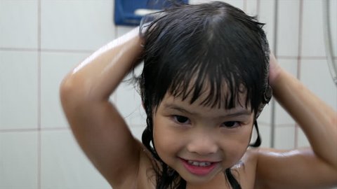 Asian child girl wash hair in the  bathroom.
