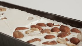 Tilting on pistachio and peanuts halva 4K footage