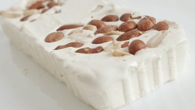 Halva with nuts on white background 4K video