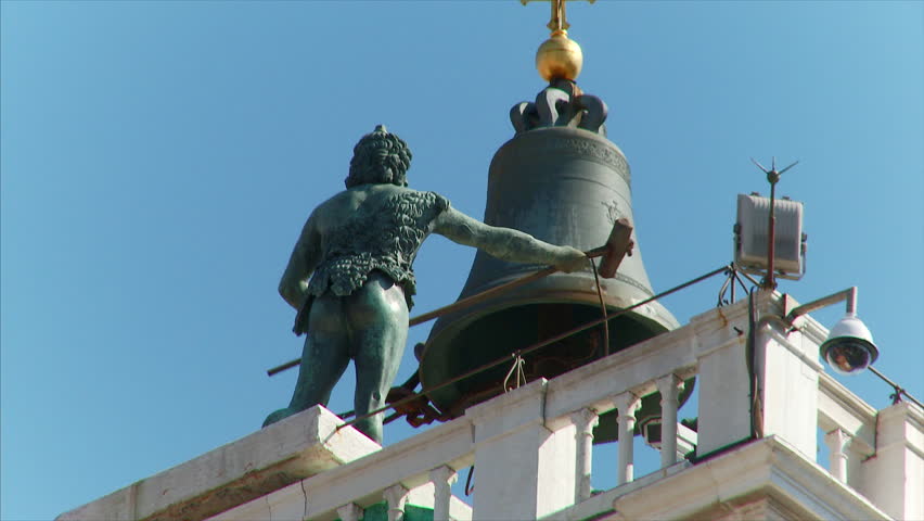 Venice, Italy : static shot of bronze statue striking the bell on the St Mark