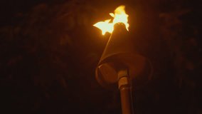 Professional video of Tiki Torch Flames Waikiki beach, Honolulu Hawaii in 4k slow motion 60fps