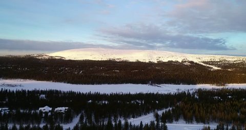 Tunturi fjeld, C4k aerial view towards snowy luostotunturi mountain fell, on a sunny winter morning dusk, in luosto, near Pyha-luosto national park, Pelkosenniemi, Lapland, Finland