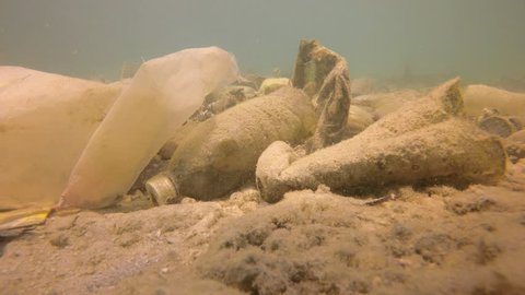 Plastic pollution of ocean. Water bottles and carrier bags dumped in sea  Video Stok