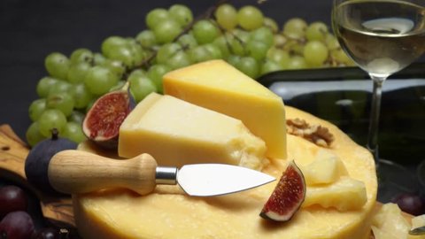 Video Whole round Head of parmesan or parmigiano hard cheese, grapes and wine