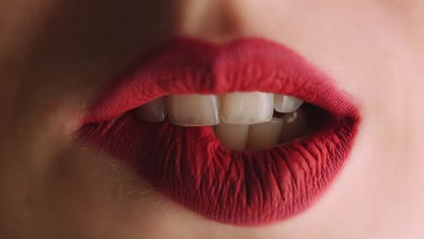 Girl sexy bites her red lips