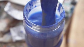 Stirring paint brush in the jar with water video